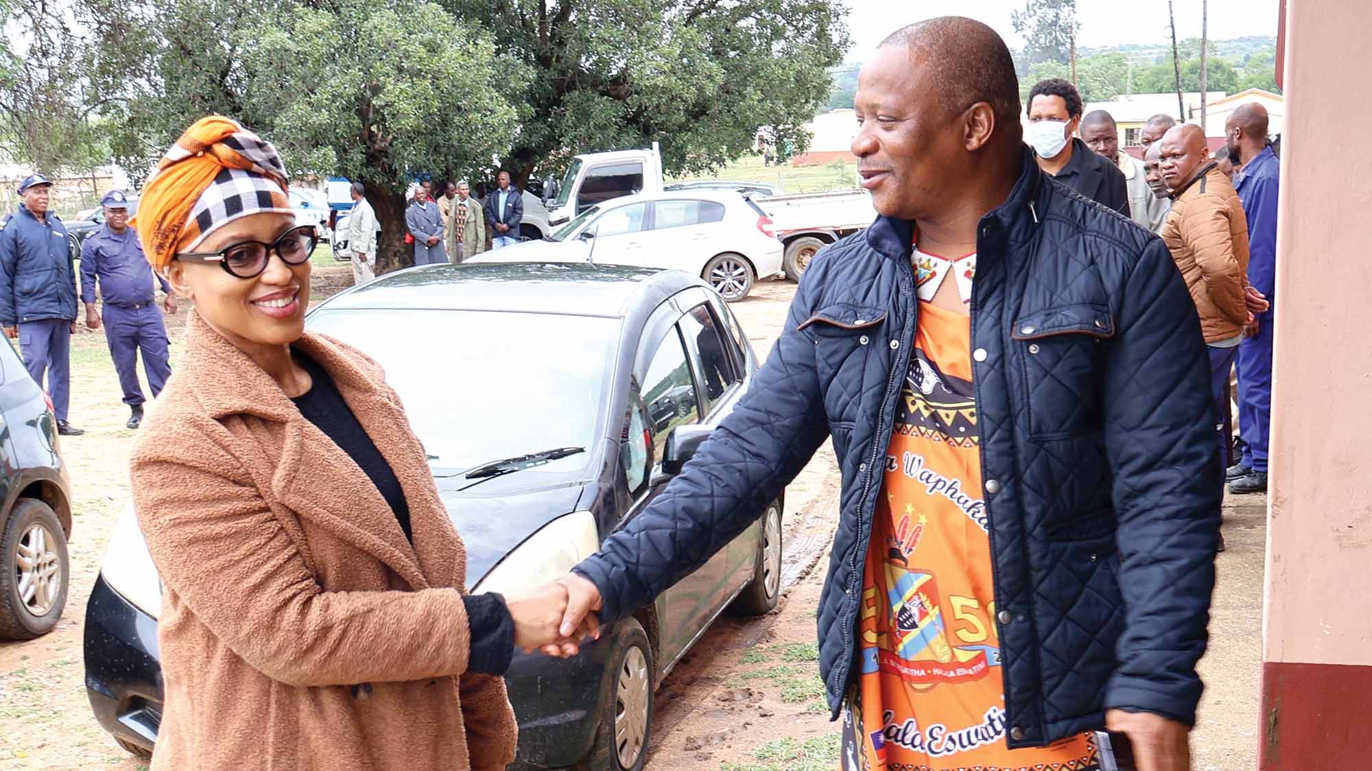 Madlenya Chief Mgwagwa Gamedze (R) greeting Ludzidzini Council member Hlobisile Ndlovu upon her arrival at Siphofaneni Inkhundla.